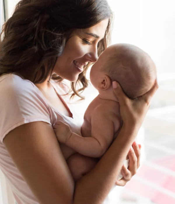 A woman holds her baby.